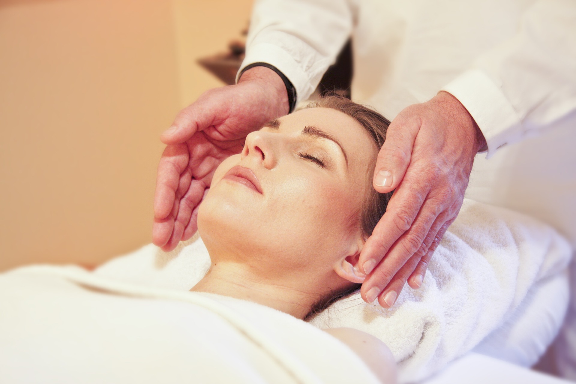 Photo of a woman lying down receiving Reiki